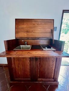 a wooden counter with a sink in a room at Podere Scoldasu - Diana in Massa Marittima
