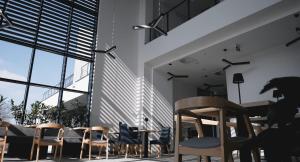 a group of chairs and tables in a restaurant at Soccer Box Pro in Dachnów