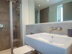 a bathroom with a sink and a shower and a toilet at Fistral Tide in Newquay +22 photos