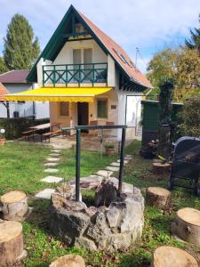 a small house with a fire pit in the yard at Kobra House in Orfű +35 photos