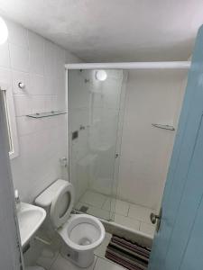 a bathroom with a shower and a toilet and a sink at Casa da Lua Buzios in Búzios