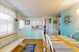 a dining room with blue walls and a table and chairs at The Eastern Avenue Cottage in Wells Beach +27 photos