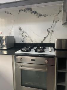 a kitchen with a stove and a counter top at HA LUXURY TWO BEDROOMED Munyonyo in Gaba