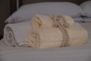 two towels stacked on top of a bed at Otto Apartment Montecatini in Montecatini Terme +29 photos