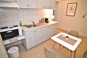 a small kitchen with a sink and a table at Polyxeni's apartment in Kastoria