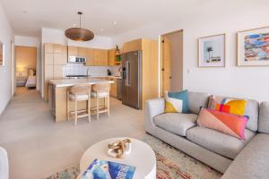 a living room with a couch and a table at Beautiful Beachfront Condo, Five-Star Amenities in El Pescadero