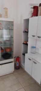 a kitchen with a white refrigerator with its door open at Casa Ponte Branca em Paraty in Paraty