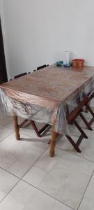 a table covered in plastic with two chairs around it at Casa Ponte Branca em Paraty in Paraty +7 photos