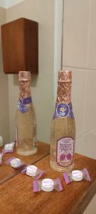 two bottles of honey sitting on a wooden table at Casa Mina in Cavallasca