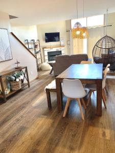 a living room with a wooden table and a couch at Waterfront Boho Retreat in Wisconsin Dells