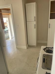 a kitchen with a stove and a white counter top at Hancock weho in Los Angeles +5 photos