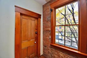 a wooden door and a window in a room at Walk to Everything - Sports, Food, Music, Downtown in Cincinnati +5 photos