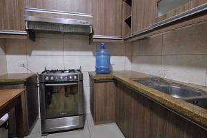 a kitchen with a bottle of water sitting on the counter at Departamento Entero in Vallejos