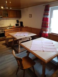 a kitchen with two wooden tables in a room at Gästehaus Erika in Marschall