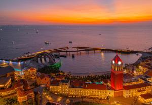 an aerial view of a city with a clock tower at Thala Hotel Sorrento in Phú Quốc