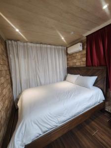 a large white bed in a small room at Suyu Station Motel in Seoul