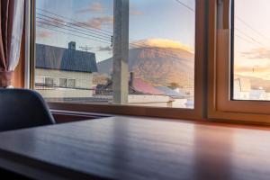 a window with a view of a mountain view at Winter Whale Lodge in Kutchan +23 photos