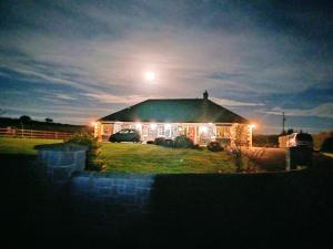 a house lit up at night with a full moon at Country Haven eircode H54 AK31 in Galway