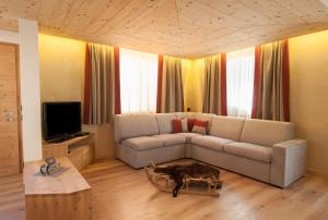 a living room with a couch and a table at Chalet Alfonz in Bormio
