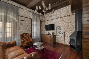 a living room with a couch and a chair at Stoes Boutique Hotel in Ioannina