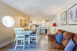 a living room with a couch and a table and chairs at Solare Garden Villa #773 in South Padre Island
