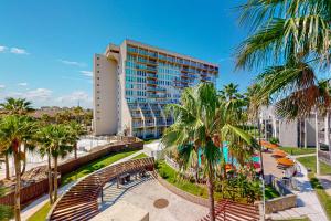 a view of the resort from the beach with palm trees at Solare Garden Villa #773 in South Padre Island