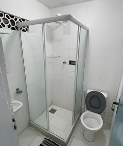 a bathroom with a shower and a toilet at Casa da Lua Buzios in Búzios +19 photos