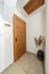 a hallway with a door and a potted plant at Central Hideaway Suite in Novi Sad