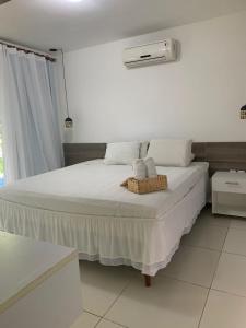 a bedroom with a bed with two towels on it at Villas Supreme Apartamentos in Maceió
