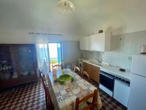 a kitchen with a table and chairs and a kitchen with a table and a table at Appartamento nello splendido Borgo di Sant'Ambrogio - Dimora Rosetta in SantʼAmbrogio