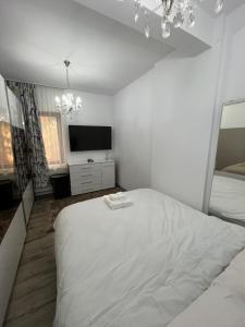 Ένα ή περισσότερα κρεβάτια σε δωμάτιο στο Central Cozy Apartament