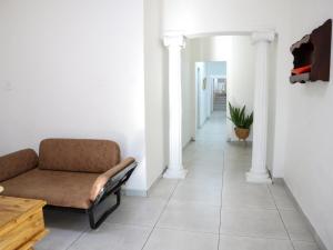 a living room with a couch and a hallway at Casa Palmeira in Nelspruit