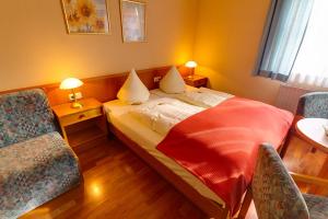 Ένα ή περισσότερα κρεβάτια σε δωμάτιο στο Hotel Tilman