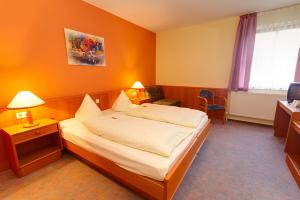 Postel nebo postele na pokoji v ubytování Hotel Tilman + 17 fotografií