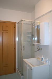 y baño con ducha, lavabo y lavamanos. en Casa Vacanze La Rocca en Matera