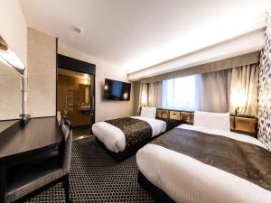 Letto o letti in una camera di APA Hotel & Resort Osaka Umeda Eki Tower