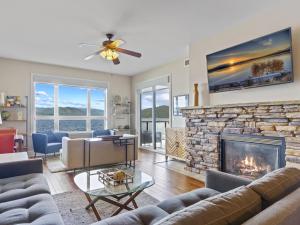 a living room with a fireplace and a stone wall at Seasons at Sandpoint - Managed by Elite Alliance in Sandpoint