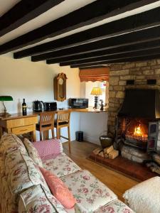 a living room with a couch and a fireplace at The Snug at Cherry Cottage by MaisonPro in Matson