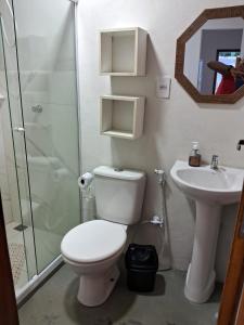 a bathroom with a toilet and a sink and a shower at Casa Natureza in Camaçari
