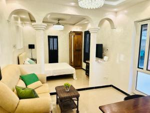 a living room with a couch and a bed at Rooftop Studio with Private Sun Terrace in Ouakam