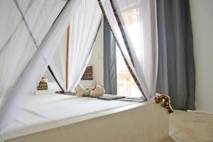 Postel nebo postele na pokoji v ubytování Blooming Zanzibar