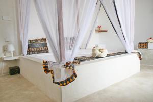 Postel nebo postele na pokoji v ubytování Blooming Zanzibar