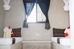 Postel nebo postele na pokoji v ubytování Blooming Zanzibar