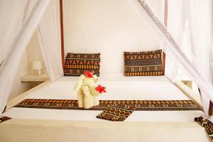 Postel nebo postele na pokoji v ubytování Blooming Zanzibar