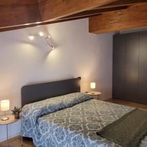 una camera da letto con un letto grande e due tavoli di Carlotta Mountain Lake Iseo Hospitality a Bossico