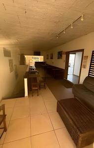 a living room with a couch and a table at Viva sol hospedagem in Cabo Frio