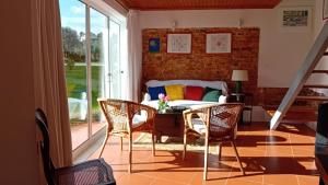 a living room with a couch and a table and chairs at Casa da Tília in Caxarias