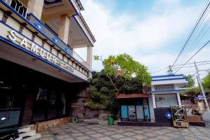 a building with a sign on the side of it at Samudra Hotel in Jepara