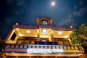 a building with a clock on top of it at Samudra Hotel in Jepara