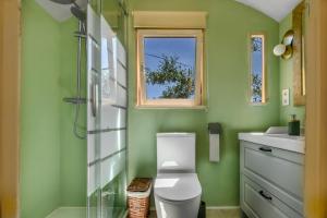 a bathroom with a toilet and a sink and a window at Casa el Refugio Stilte Comfort Natuur Uniek in Canillas de Aceituno +10 photos